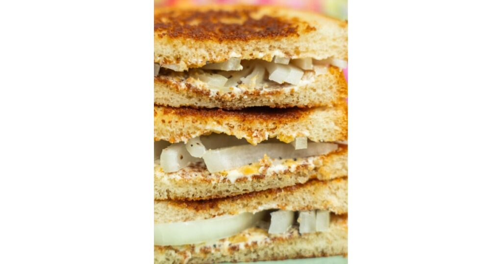 Stacked pieces of bread and onion alternating.
