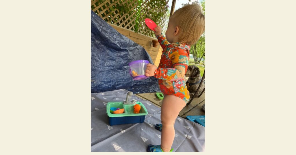 Toddler doing water play