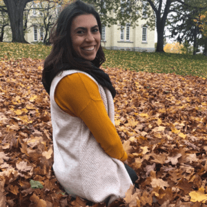 Hailey in leaves with yellow sweater