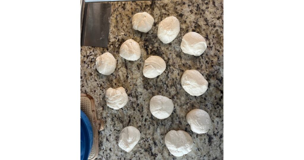 Sourdough bagel balls on marble countertop.