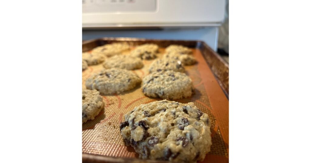 Oatmeal chocolate chip cookies with one in focus.