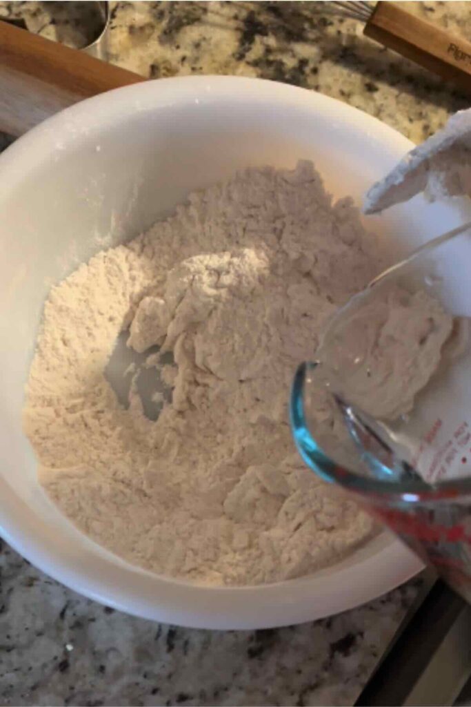 Water pouring into salt and flour.