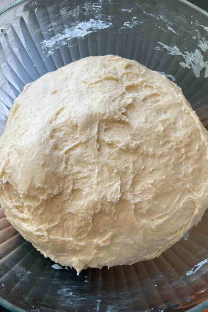 bulk fermented dough in a glass bowl.