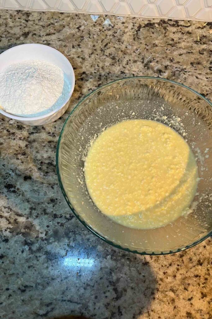 two bowls of wet and dry ingredients to make sourdough rolls.