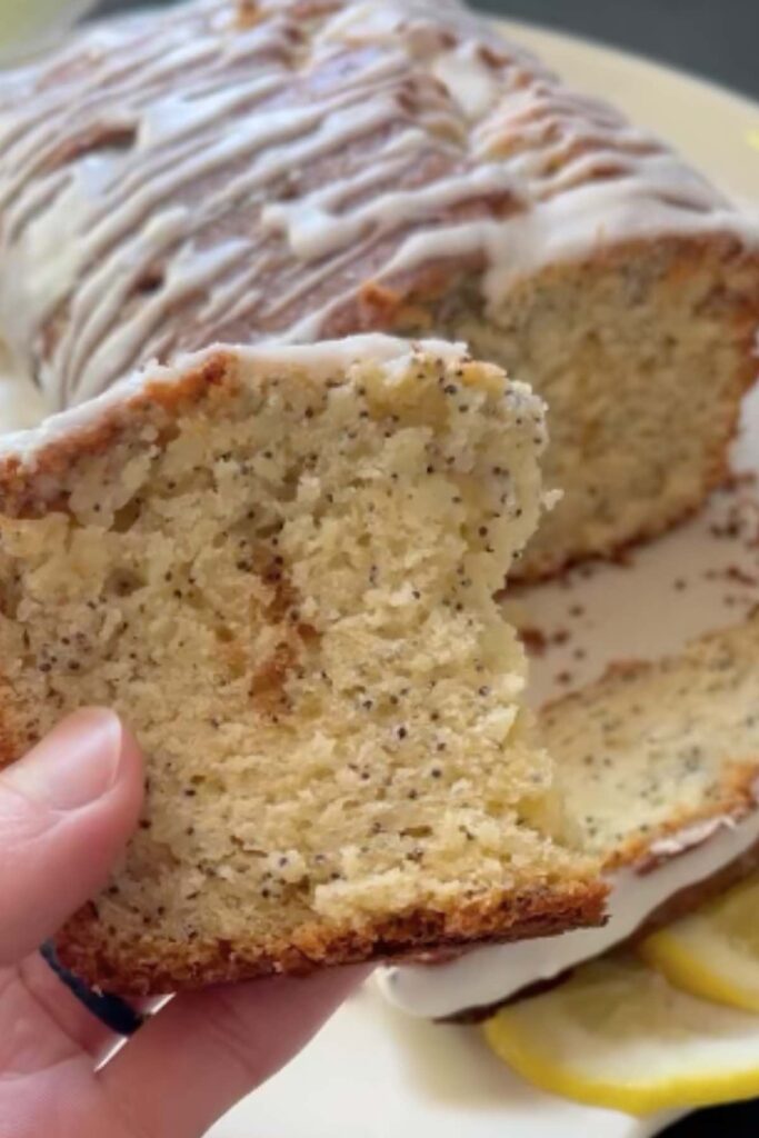 slice of lemon poppyseed bread in front of bread.