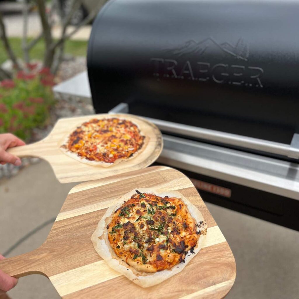 two sourdough pizzas on pizza peels.