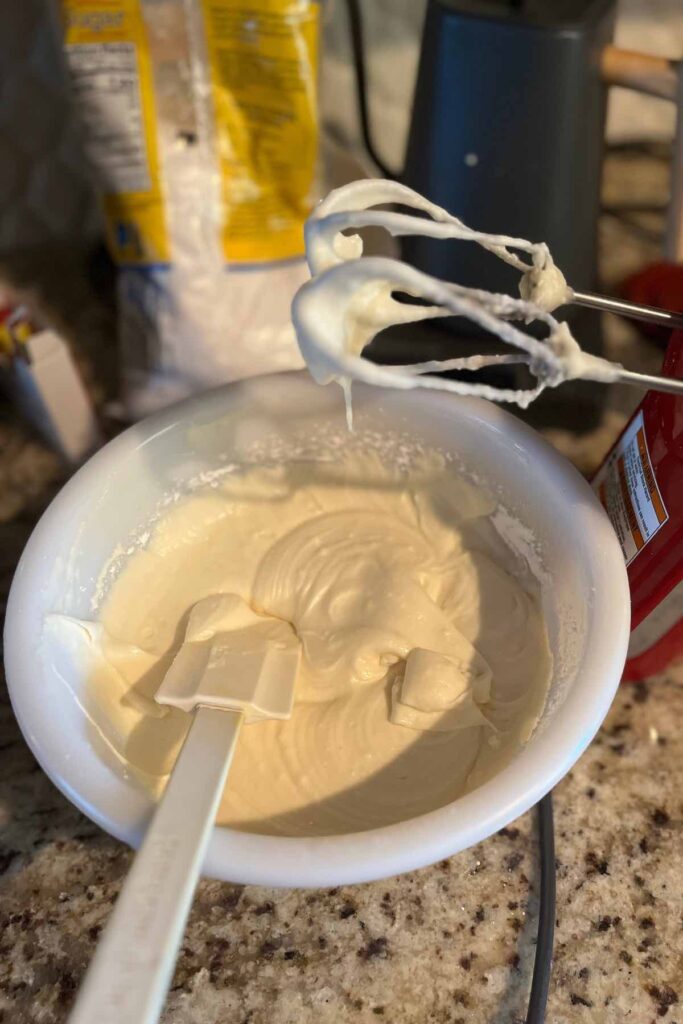 royal icing on beaters and in a bowl.