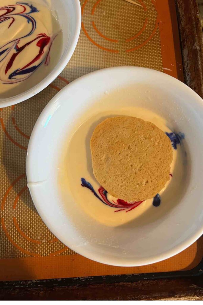 sugar cookie in bowl with royal icing.