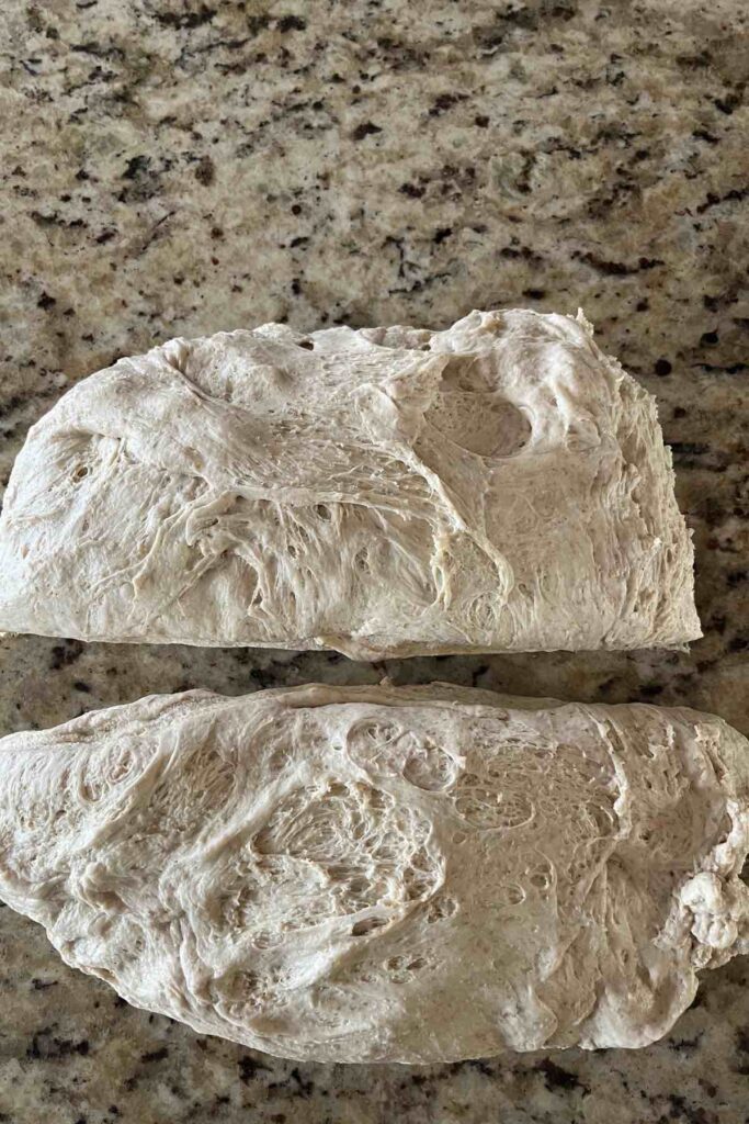 sourdough loaf split in two on a countertop.