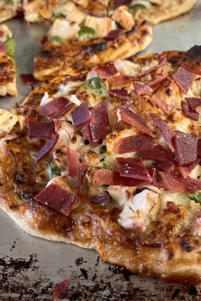 sourdough bbq chicken pizza on platter.