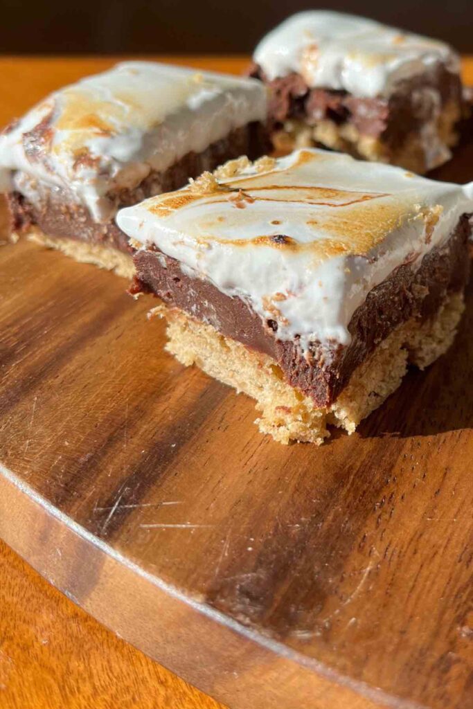 sourdough fudge bars on a wooden cutting board.