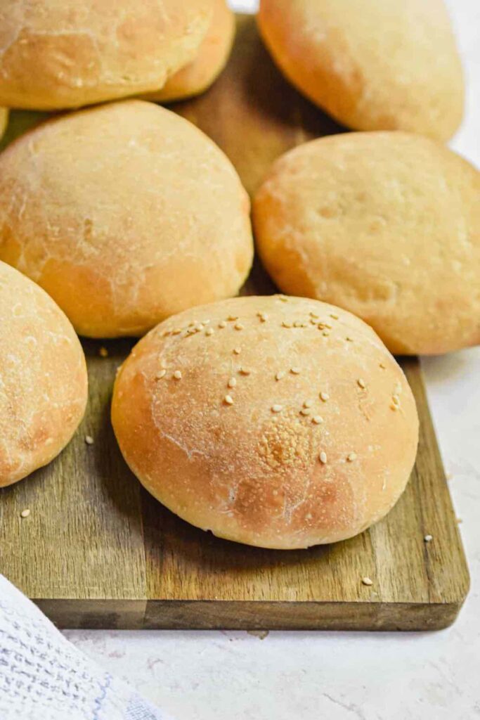 sourdough hamburger buns on a plate.