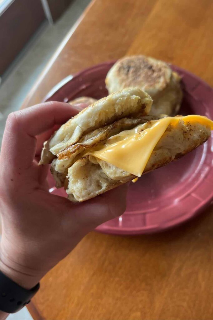 hand holding a sourdough breakfast sandwich