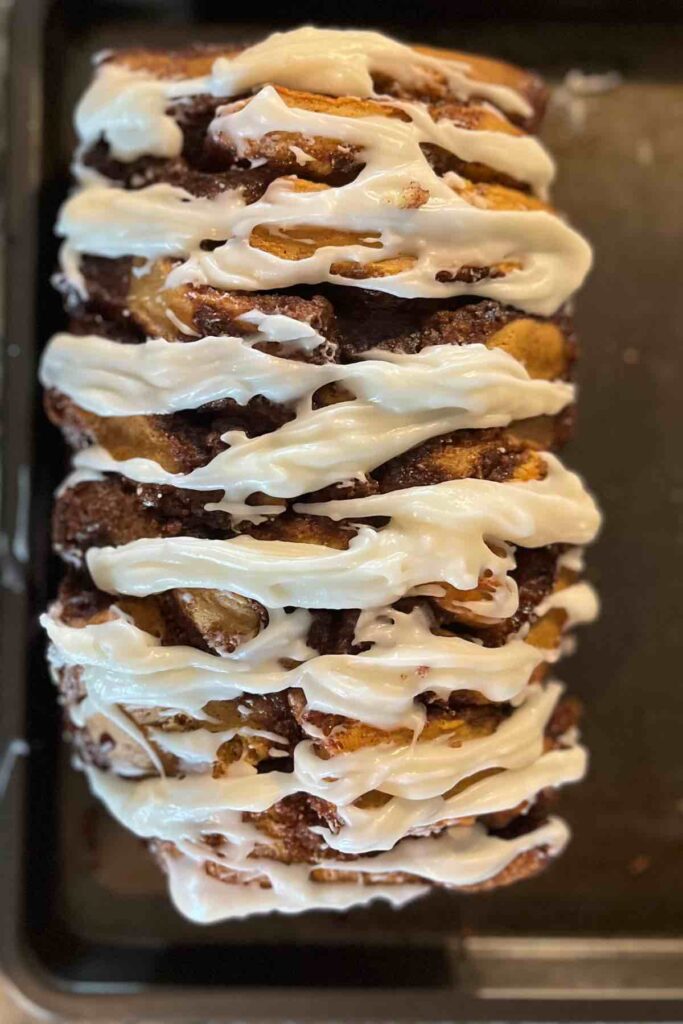 sourdough cinnamon roll pull apart bread with cream cheese frosting.