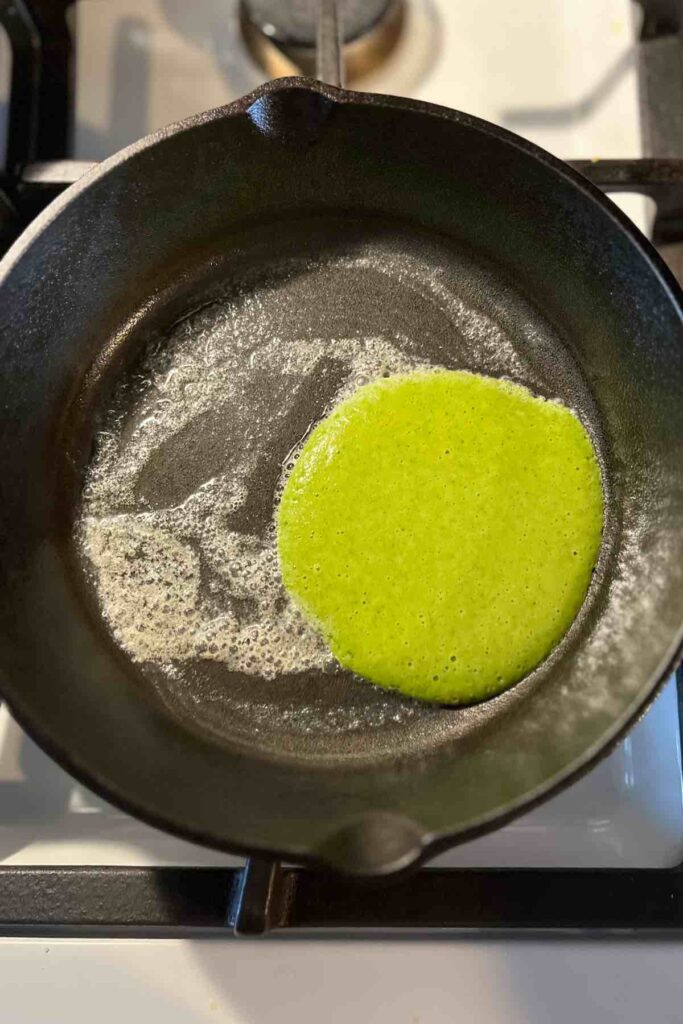 sourdough green pancake in cast iron skillet