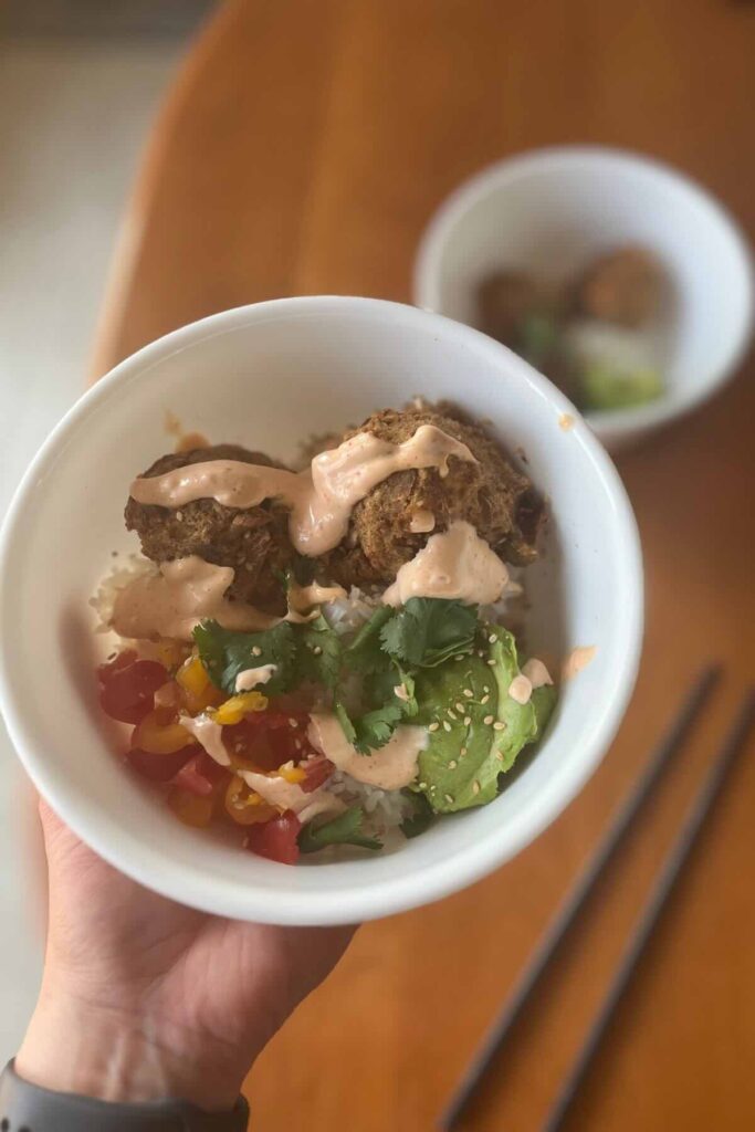 tuna cakes in a bowl with chopsticks.