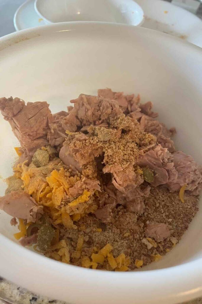 canned tuna mash in white bowl.