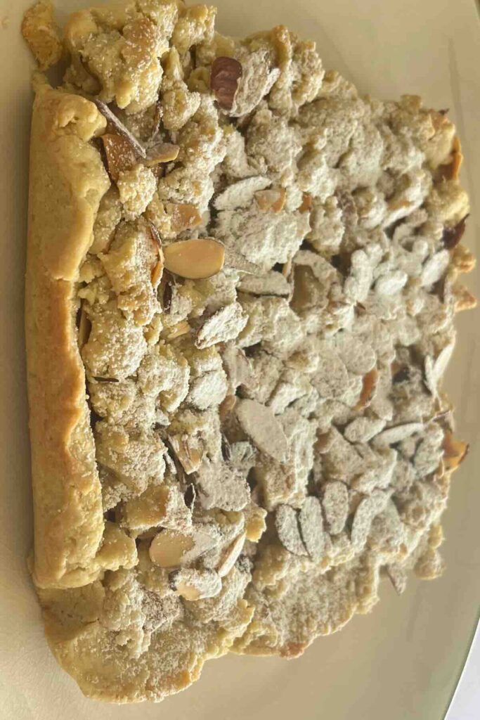 powdered sugar ad sliced almonds on top of bar.