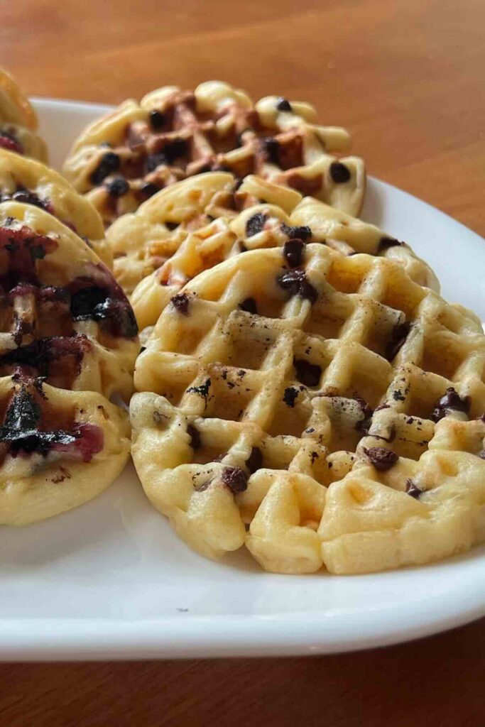 chocolate sourdough waffles on white plate.