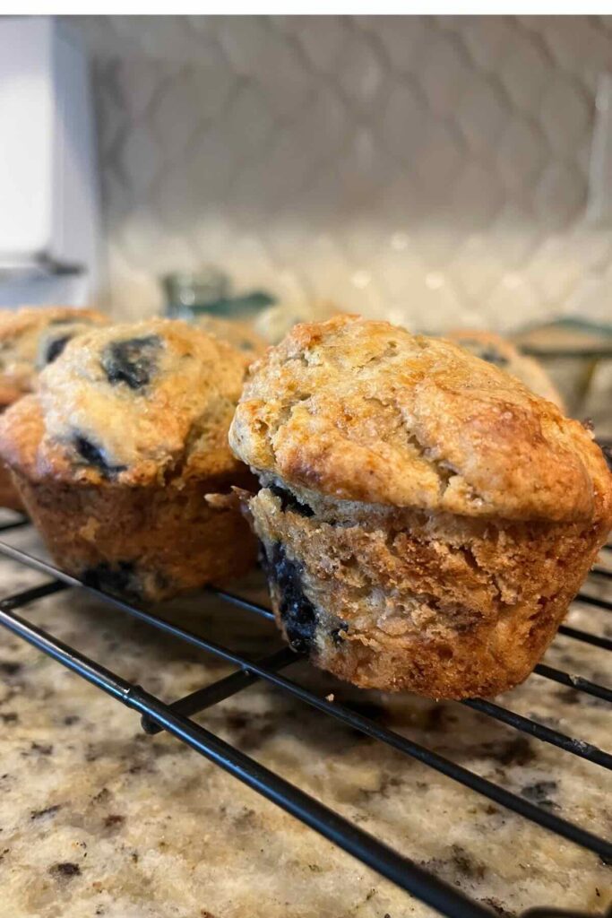 baked blueberry muffins on wire rack.