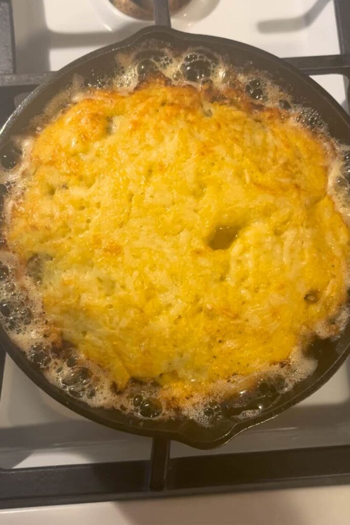 savory sourdough dutch baby in pan.