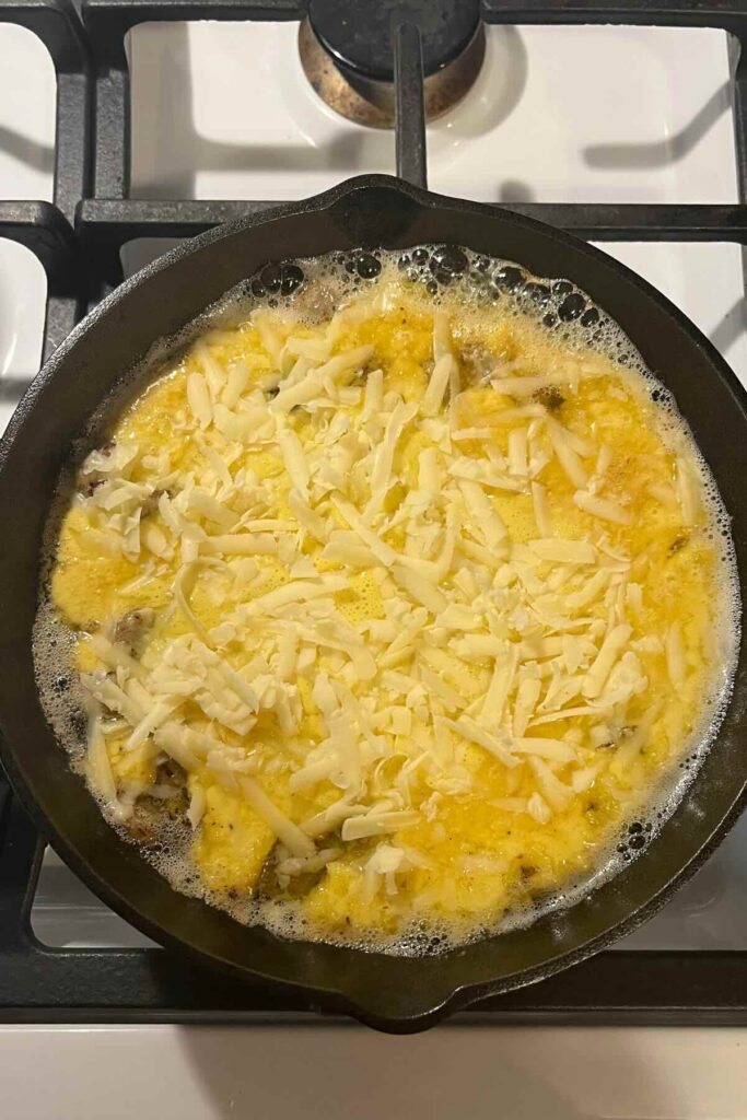 savory sourdough dutch baby with white cheddar cheese on top.