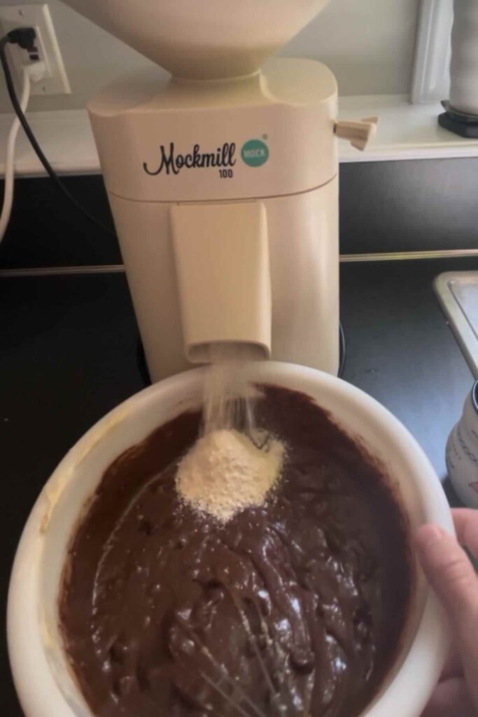 fresh milled flour over sourdough brownie batter.