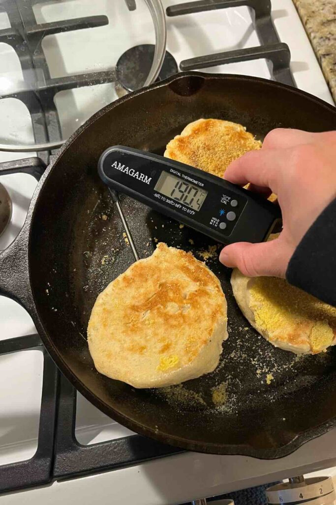checking English muffin temperature with thermometer.