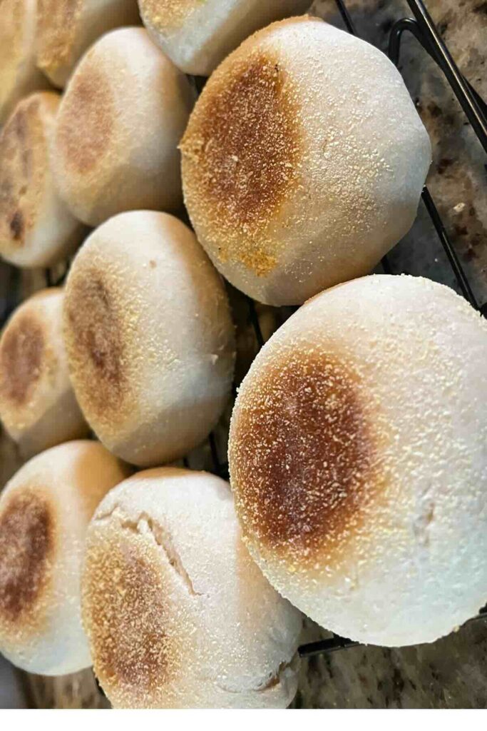 sourdough English muffins on cooling rack.