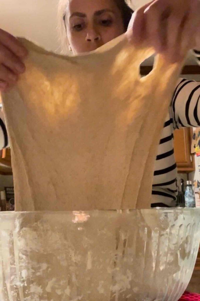 pulling sourdough bread with hands.