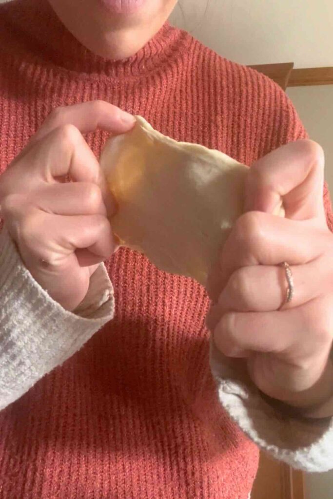 stretching sourdough bread.