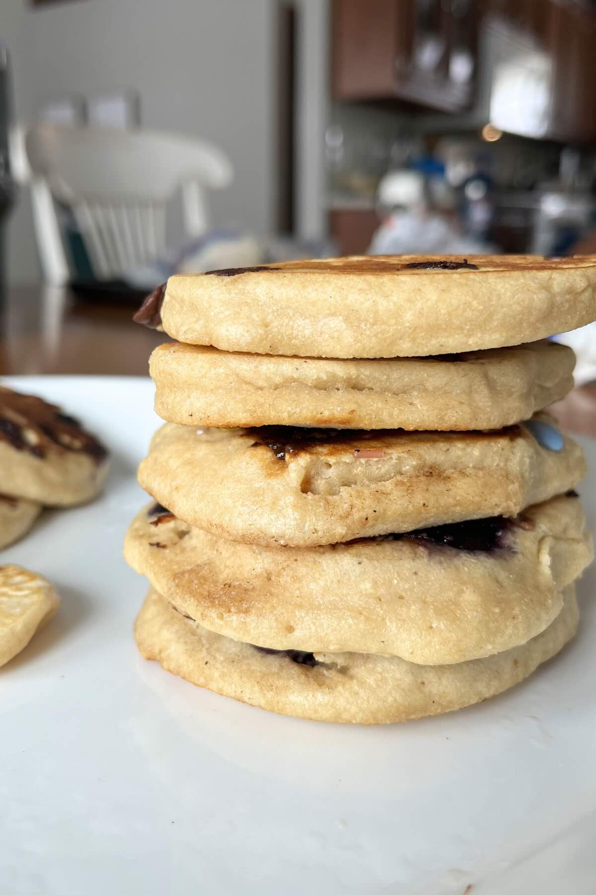stack of freshly milled flour protein pancakes on a white plate.