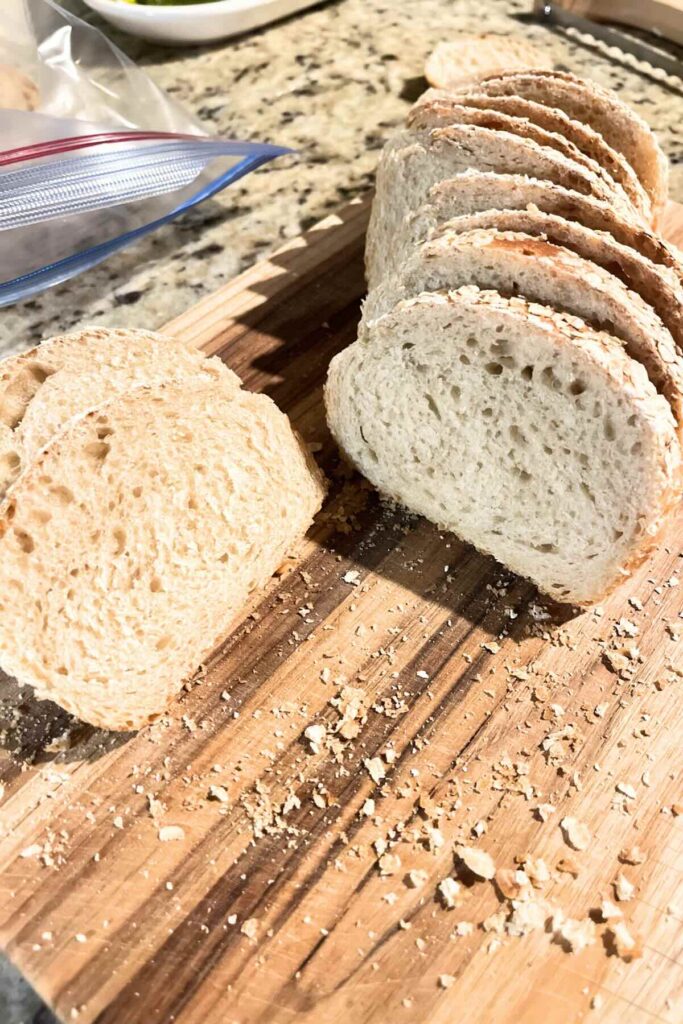 honey wheat sourdough bread on a wooden cutting board.