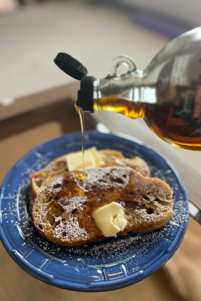 sourdough French toast with maple syrup poured on top.