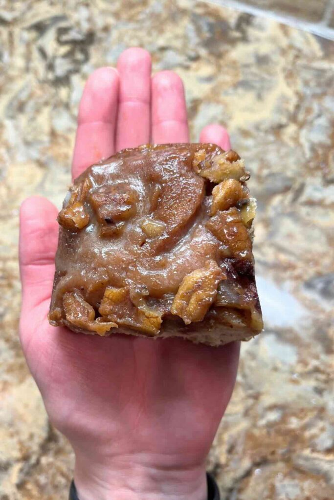sourdough sticky buns in hand.