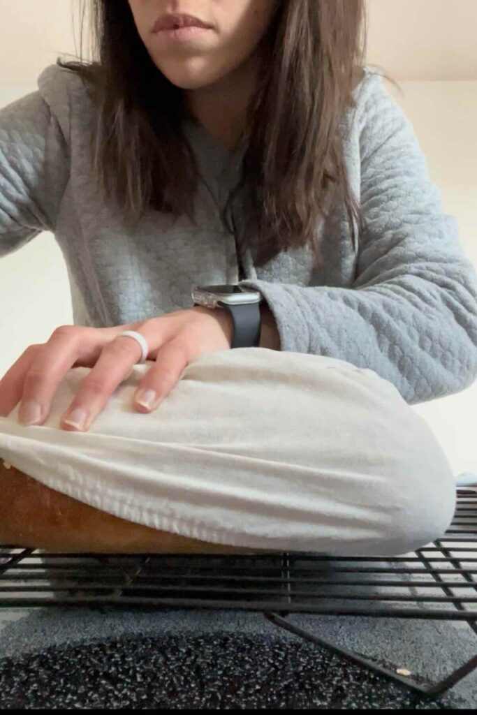 sourdough bread wrapped in a towel.