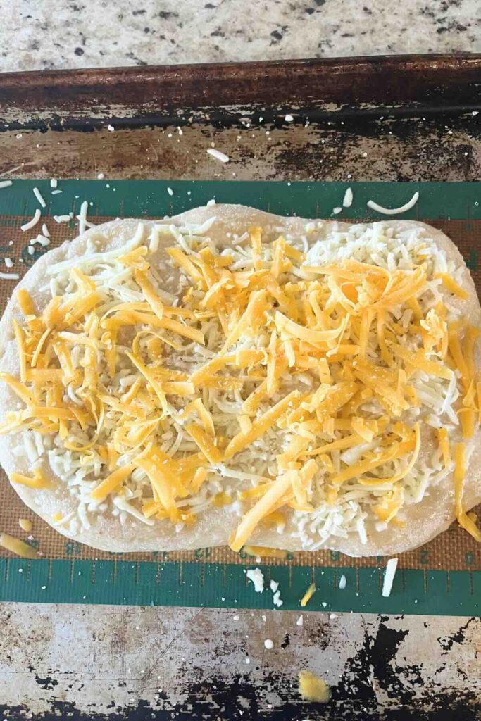 cheese on top of sourdough pizza crust.