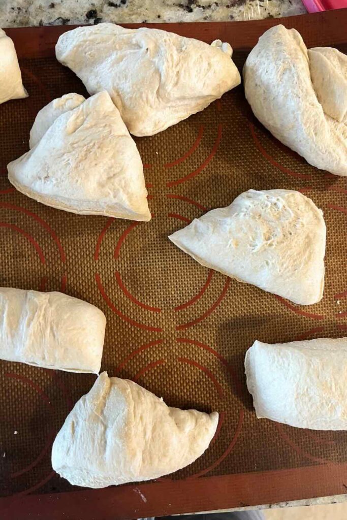 Honey oat bagel dough cut into sections.
