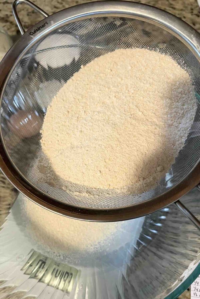 sifting fresh milled flour to reduce bran.