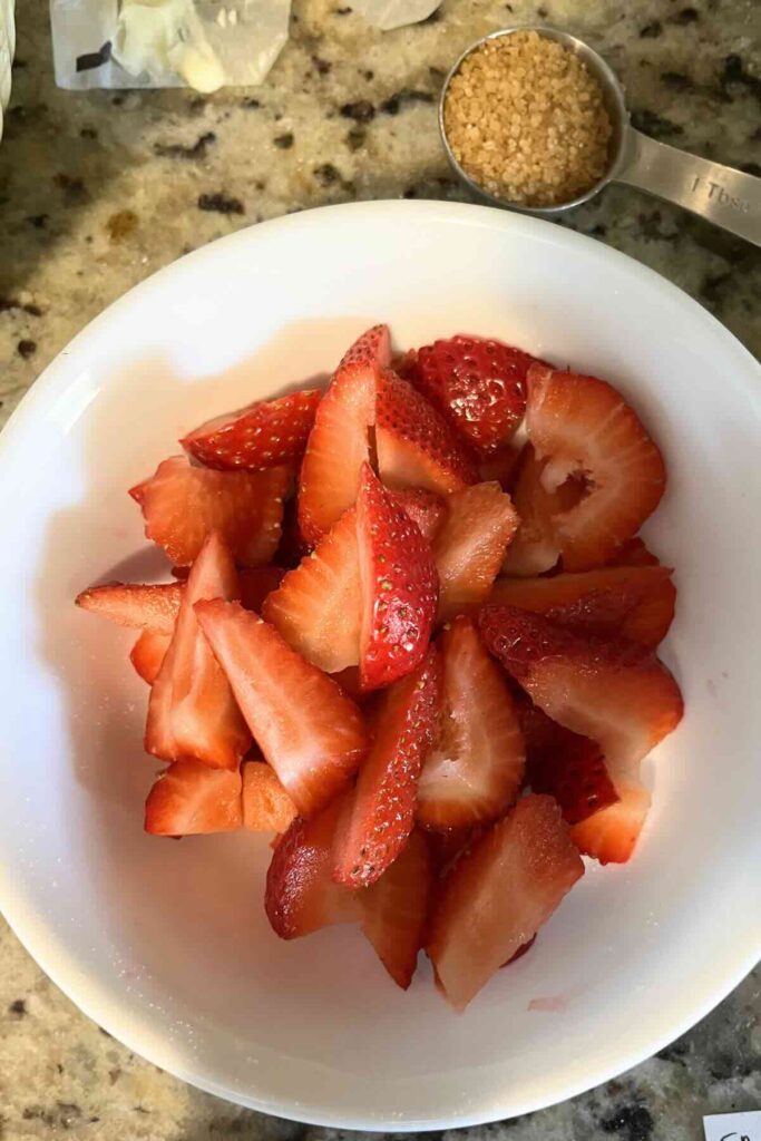 fresh sliced strawberries in a bowl.