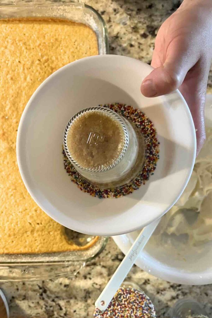 add sprinkles to dot cake.