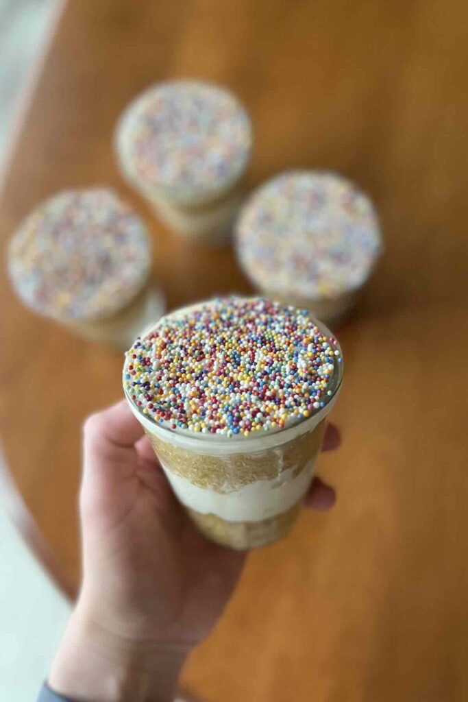 hand holding vanilla dot cake.