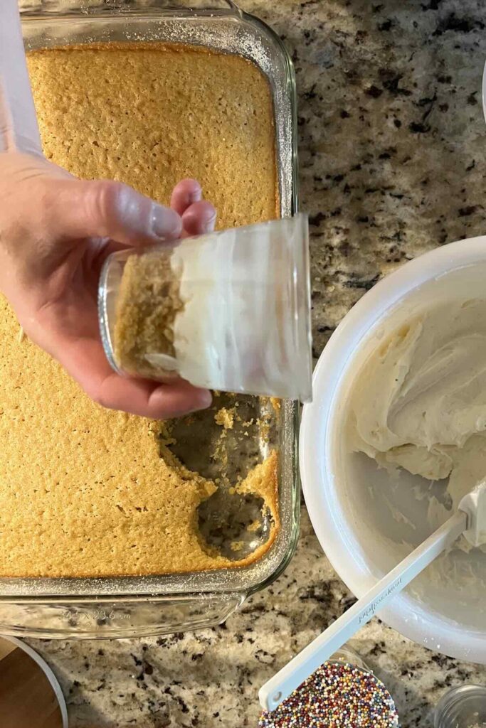 first layer of cake and frosting in a glass.